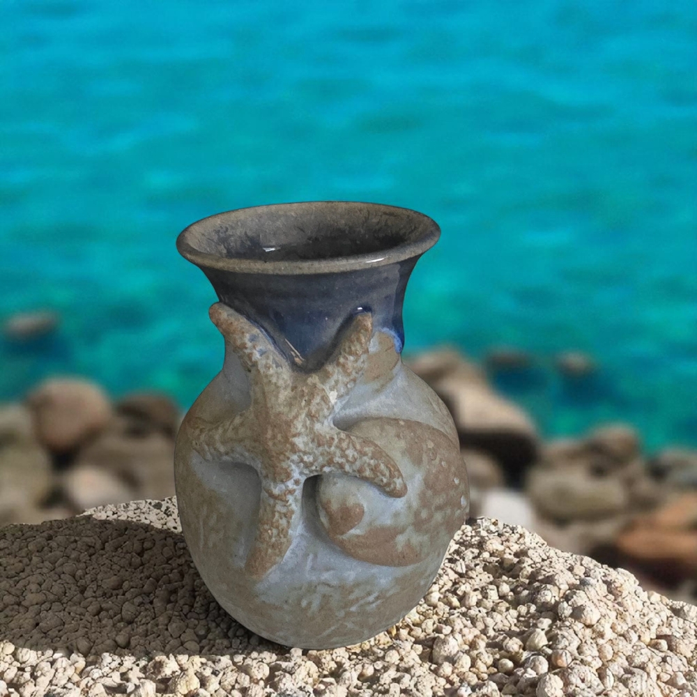 vintage Raku studio pottery vase featuring a starfish and shell design